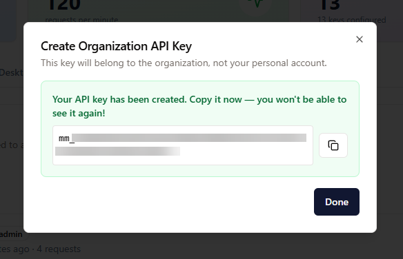 Dialogen “Create Organization API Key” med en kopiér-knap og en advarsel om at kopiere nøglen nu.